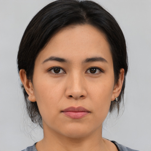Joyful asian young-adult female with medium  brown hair and brown eyes