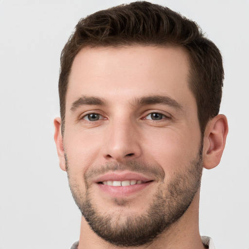 Joyful white young-adult male with short  brown hair and brown eyes