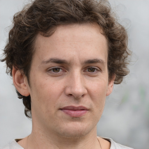 Joyful white adult male with short  brown hair and grey eyes