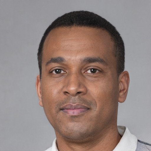 Neutral black adult male with short  black hair and brown eyes