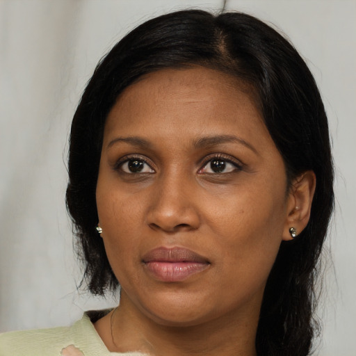 Joyful black young-adult female with medium  brown hair and brown eyes