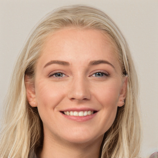 Joyful white young-adult female with long  brown hair and blue eyes