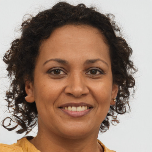 Joyful black adult female with short  brown hair and brown eyes