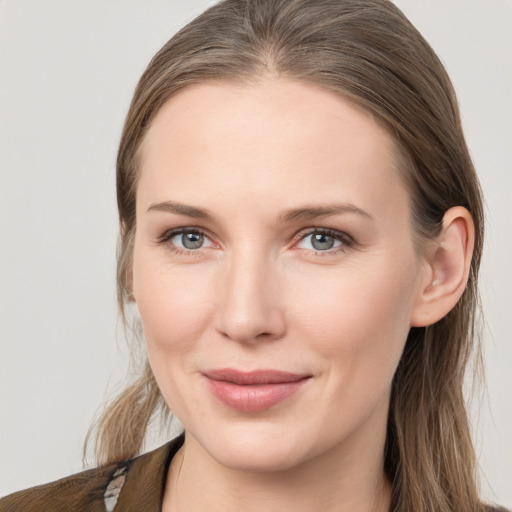 Joyful white young-adult female with medium  brown hair and grey eyes