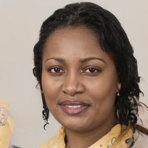 Joyful latino adult female with medium  black hair and brown eyes