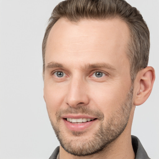 Joyful white adult male with short  brown hair and brown eyes