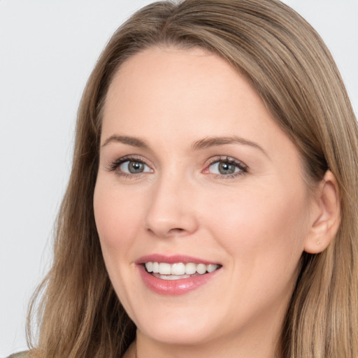 Joyful white adult female with long  brown hair and brown eyes