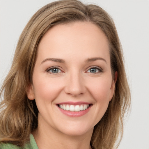 Joyful white young-adult female with medium  brown hair and green eyes