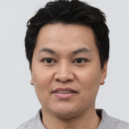 Joyful asian adult male with short  black hair and brown eyes