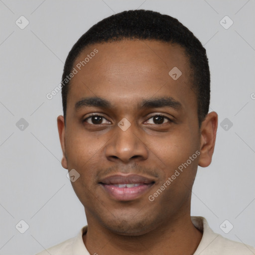 Joyful black young-adult male with short  black hair and brown eyes