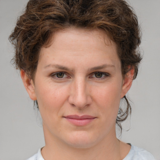 Joyful white young-adult female with medium  brown hair and green eyes