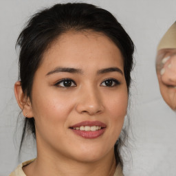 Joyful asian young-adult female with medium  brown hair and brown eyes