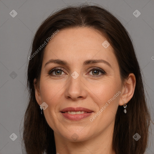 Joyful white adult female with long  brown hair and brown eyes