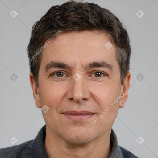 Joyful white adult male with short  brown hair and brown eyes