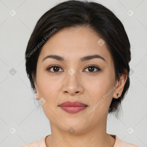 Joyful latino young-adult female with medium  brown hair and brown eyes