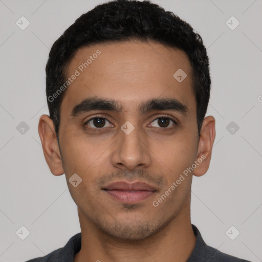 Joyful latino young-adult male with short  black hair and brown eyes