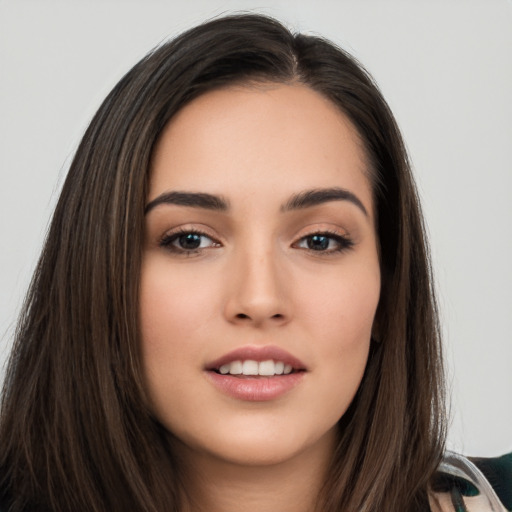 Joyful white young-adult female with long  brown hair and brown eyes