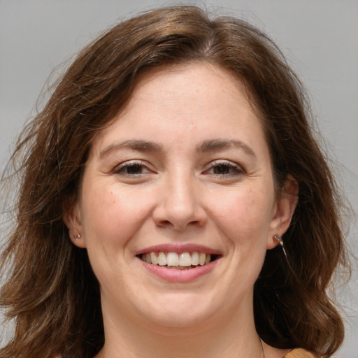 Joyful white adult female with long  brown hair and brown eyes