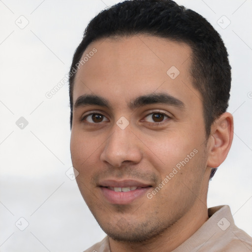 Joyful latino young-adult male with short  black hair and brown eyes