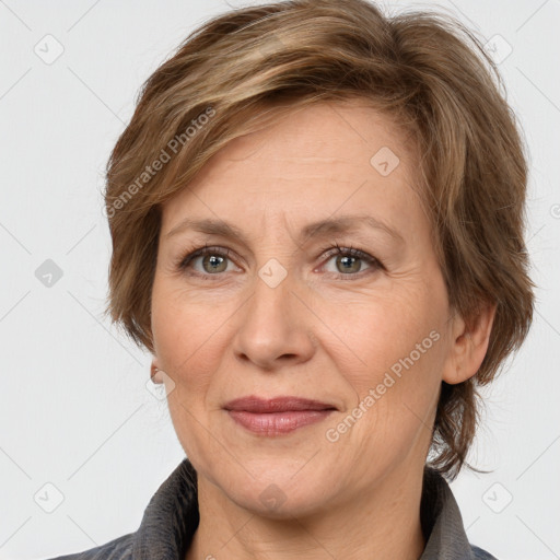 Joyful white adult female with medium  brown hair and grey eyes