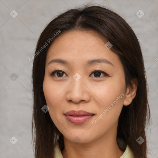 Joyful asian young-adult female with long  brown hair and brown eyes