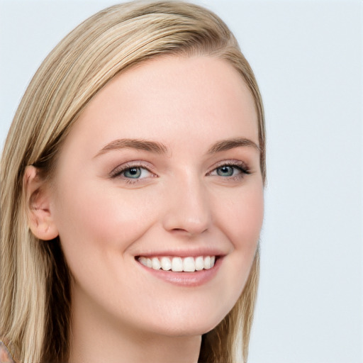 Joyful white young-adult female with long  brown hair and blue eyes