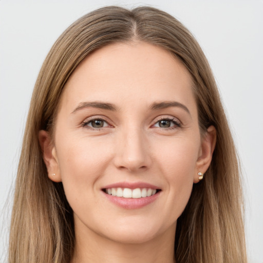 Joyful white young-adult female with long  brown hair and brown eyes