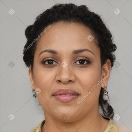 Joyful black adult female with long  brown hair and brown eyes