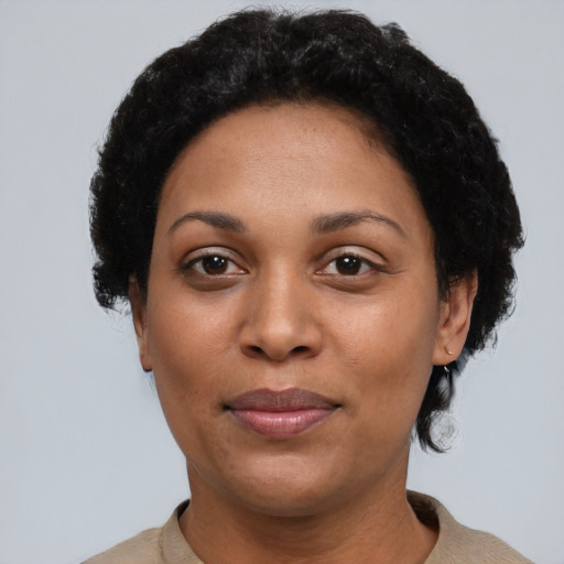 Joyful latino adult female with short  black hair and brown eyes