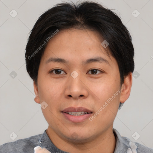 Joyful asian adult male with short  brown hair and brown eyes