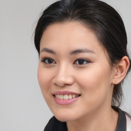 Joyful asian young-adult female with long  brown hair and brown eyes