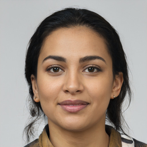 Joyful latino young-adult female with medium  black hair and brown eyes