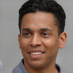 Joyful latino young-adult male with short  brown hair and brown eyes