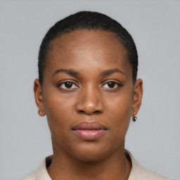 Joyful black young-adult female with short  brown hair and brown eyes