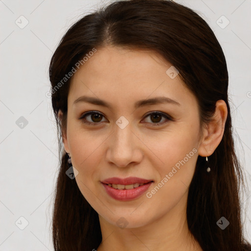 Joyful white young-adult female with long  brown hair and brown eyes