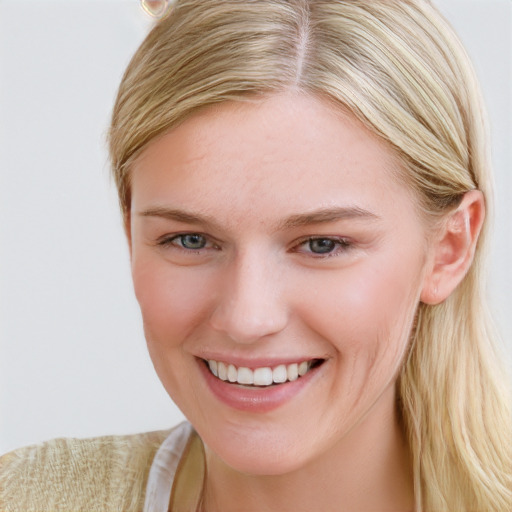 Joyful white young-adult female with long  brown hair and blue eyes