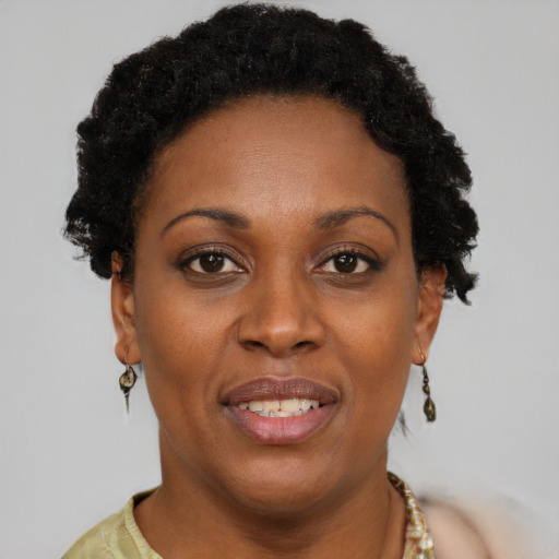 Joyful black adult female with short  brown hair and brown eyes