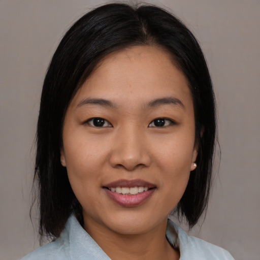 Joyful asian young-adult female with medium  black hair and brown eyes
