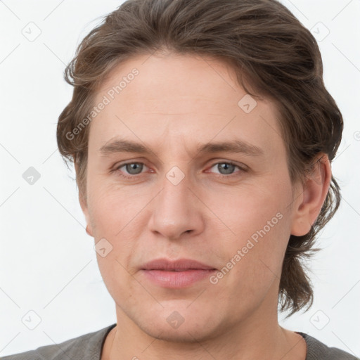 Joyful white young-adult male with medium  brown hair and grey eyes