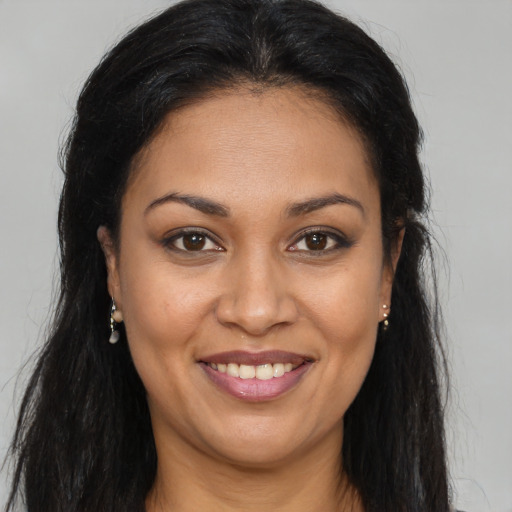 Joyful latino young-adult female with long  brown hair and brown eyes