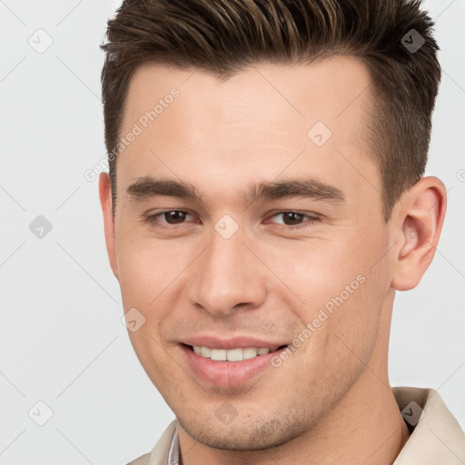 Joyful white young-adult male with short  brown hair and brown eyes