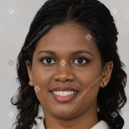 Joyful black young-adult female with long  brown hair and brown eyes