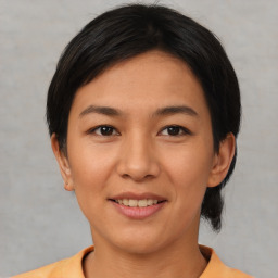 Joyful asian young-adult female with short  black hair and brown eyes