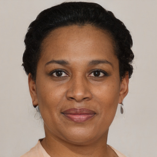 Joyful black young-adult female with short  brown hair and brown eyes