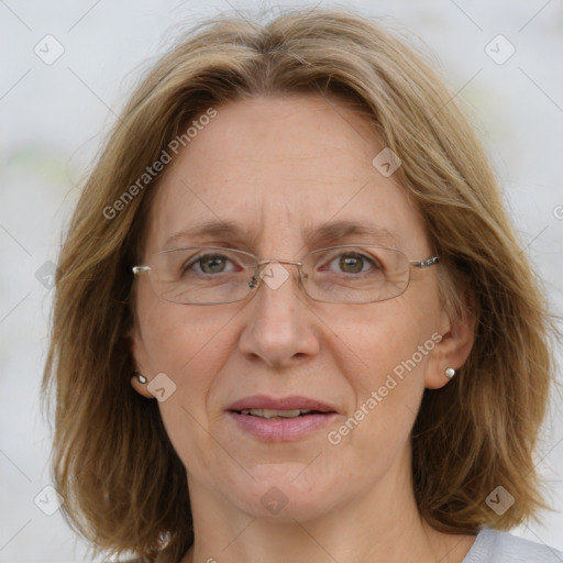 Joyful white adult female with medium  brown hair and blue eyes