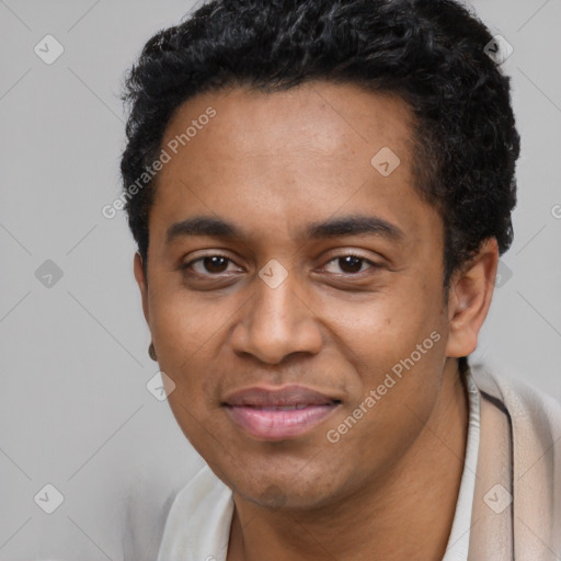 Joyful black young-adult male with short  black hair and brown eyes