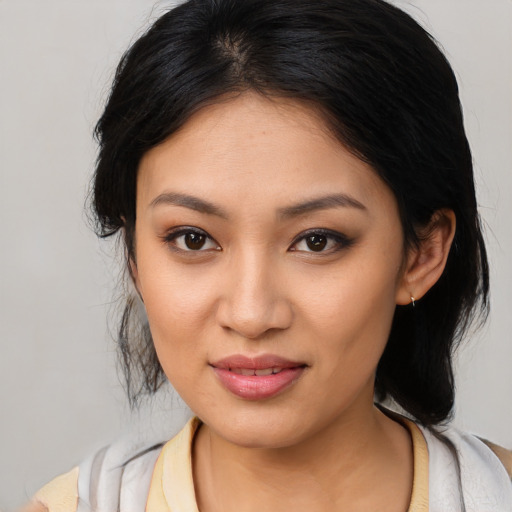 Joyful latino young-adult female with medium  brown hair and brown eyes