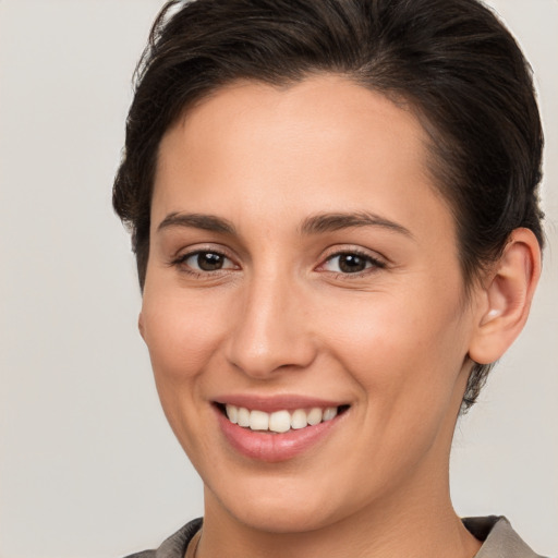 Joyful white young-adult female with short  brown hair and brown eyes