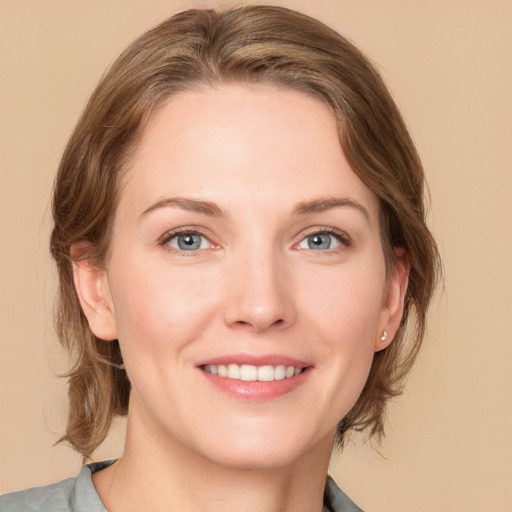 Joyful white young-adult female with medium  brown hair and blue eyes