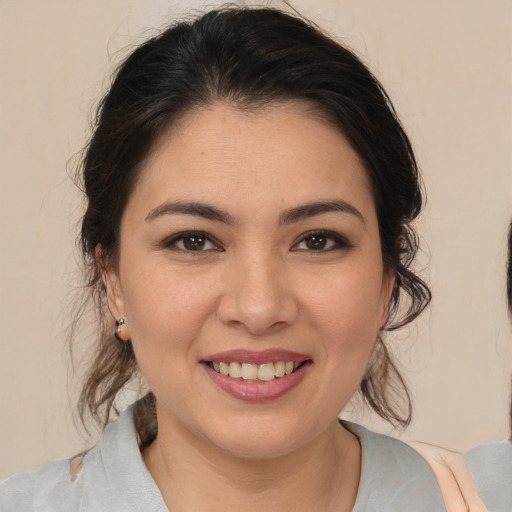 Joyful latino young-adult female with medium  brown hair and brown eyes